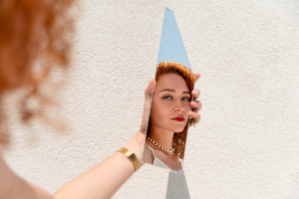 reflet d'une jeune femme dans un bout de miroir faisant référence a l'effet miroir dans les relations